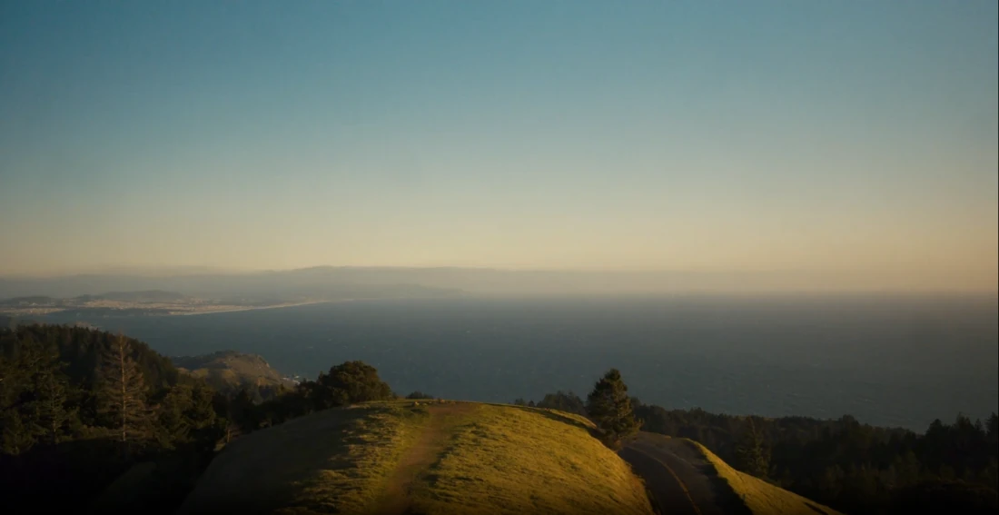 Hills above the coast in evening light.