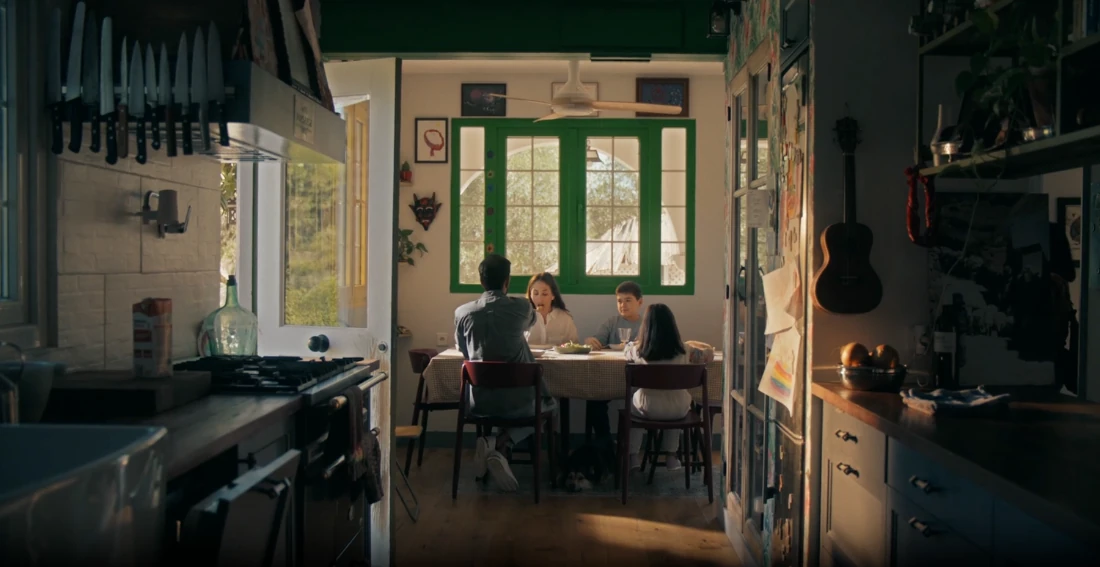 A family eating together at a kitchen table.