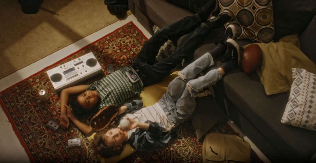 Two teenagers lying on a rug at home.