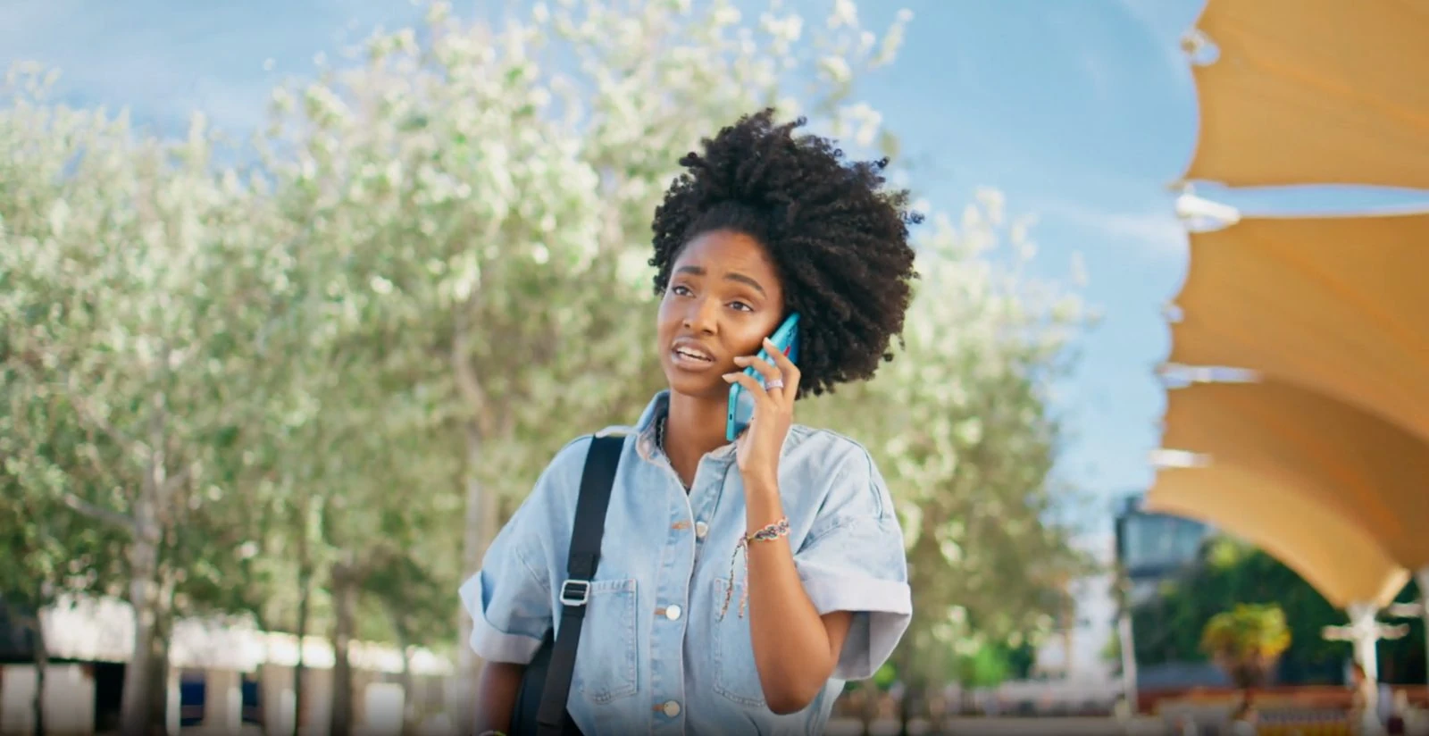 A parent on the phone, worried about a payment —  flowers at dusk.