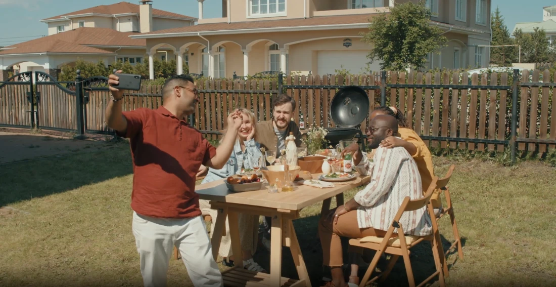 A family taking a photo around a garden table.